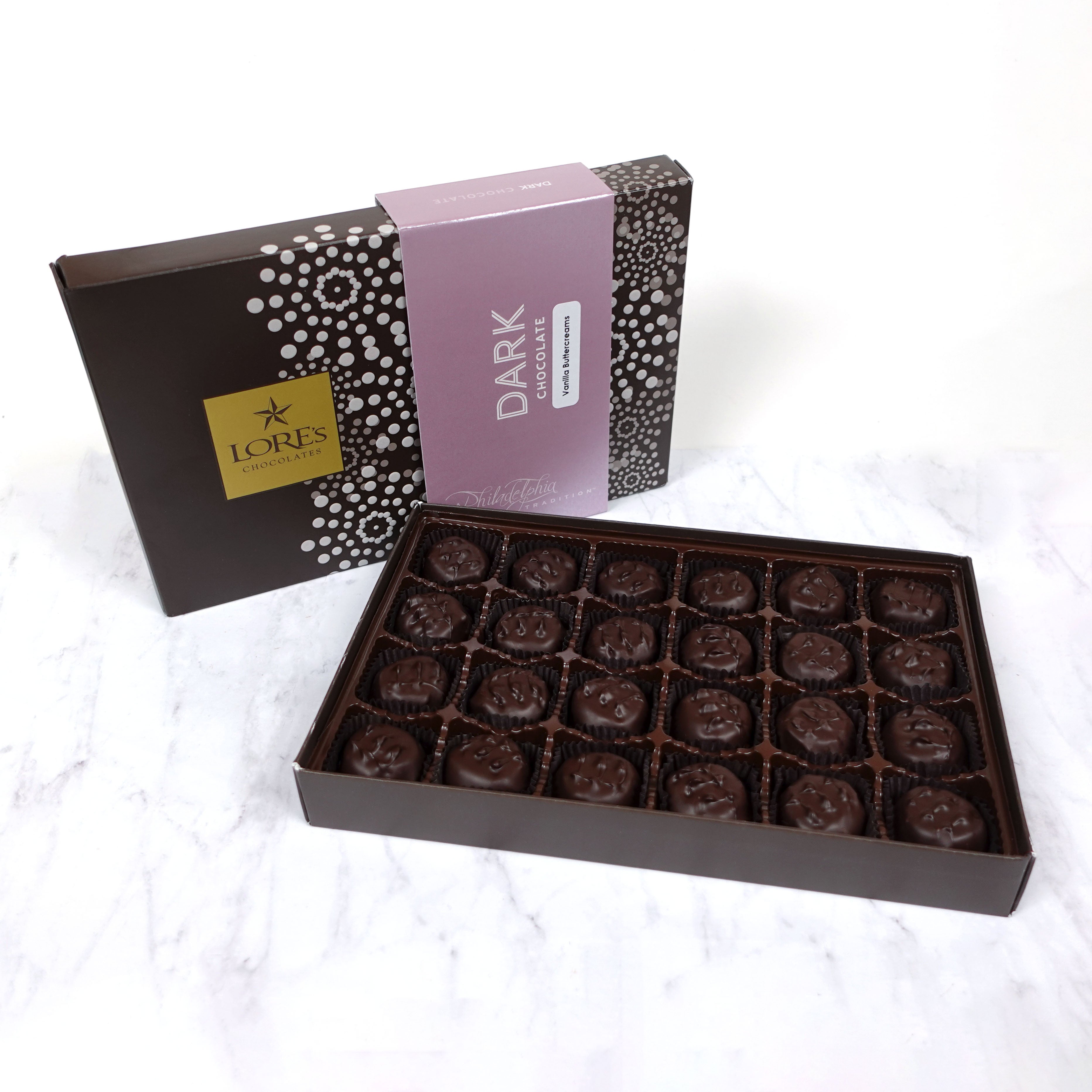 Box of dark chocolate vanilla butter creams with a Lore's Chocolates branded box on a white background