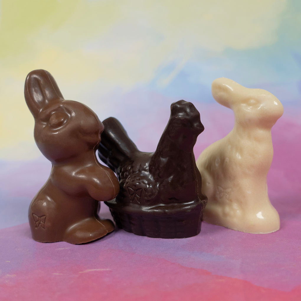 Three assorted chocolate Easter figurines on a colorful background