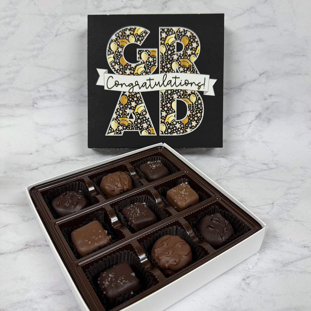 gift box of assorted chocolates with a 'Congratulations Grad' design on a marble surface - Lore's Chocolates in Philadelphia