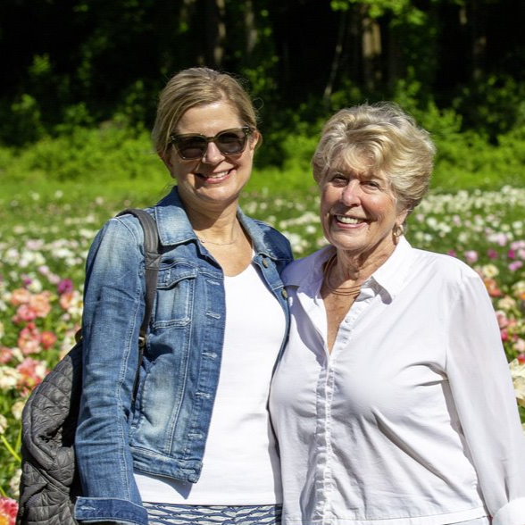 Maureen Walter on the Left and Midge Walter on the right, with a field of wildflowers behind them out of focus.