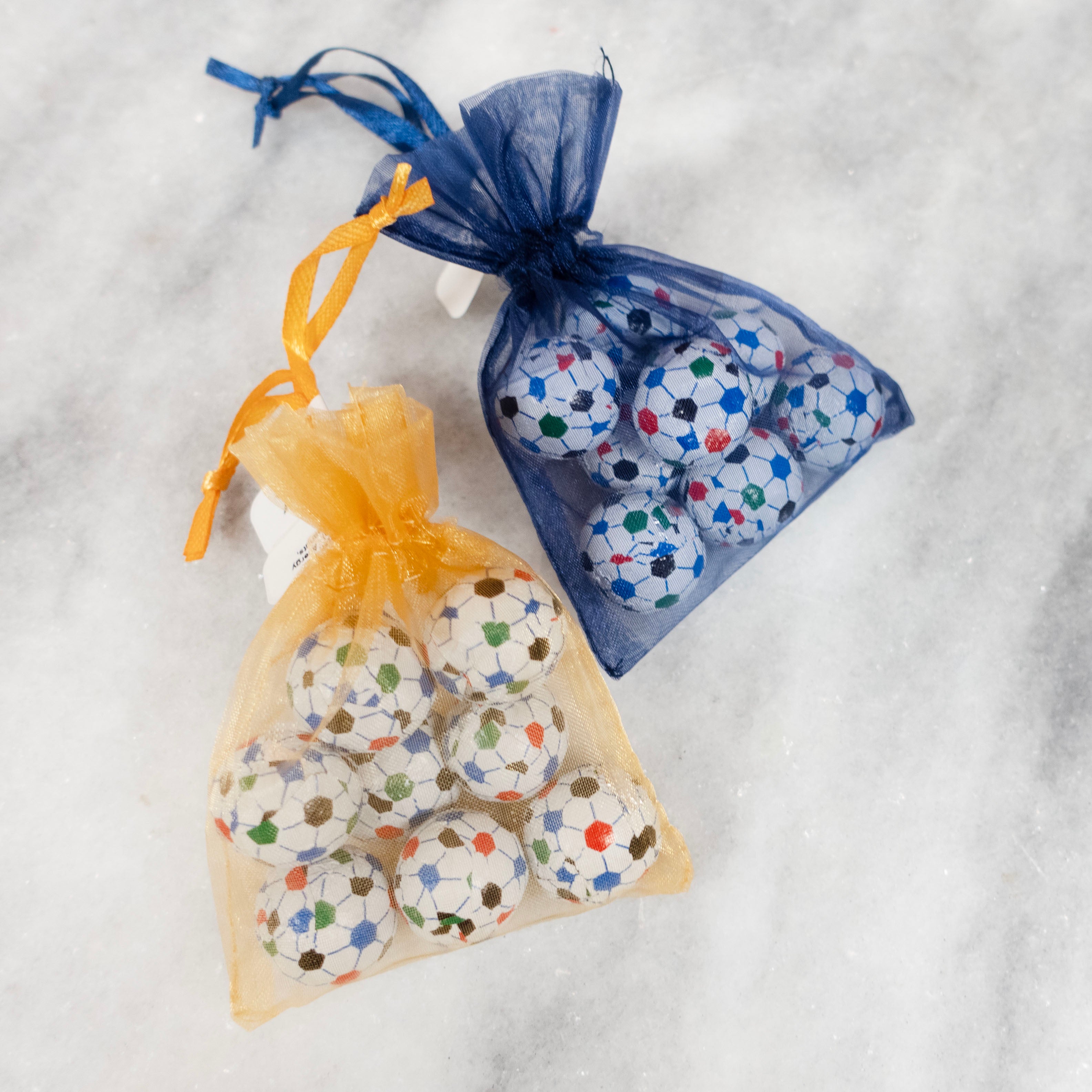 Philly Union Soccer Balls Solid Milk Chocolate in gold and navy blue organza bags.