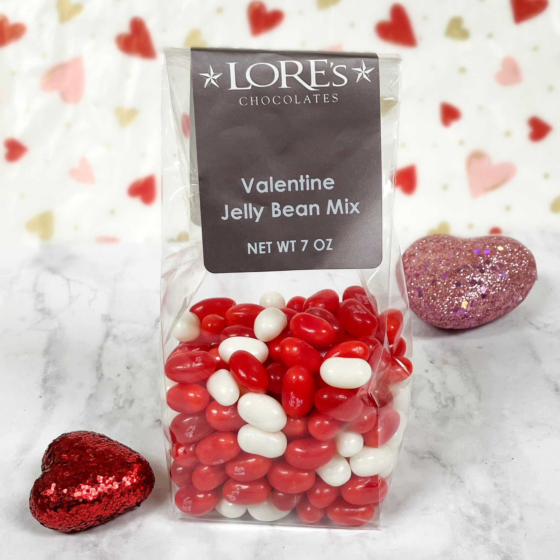 Bag of Lore's Chocolates Valentine Jelly Bean Mix with decorative hearts on a marble surface.