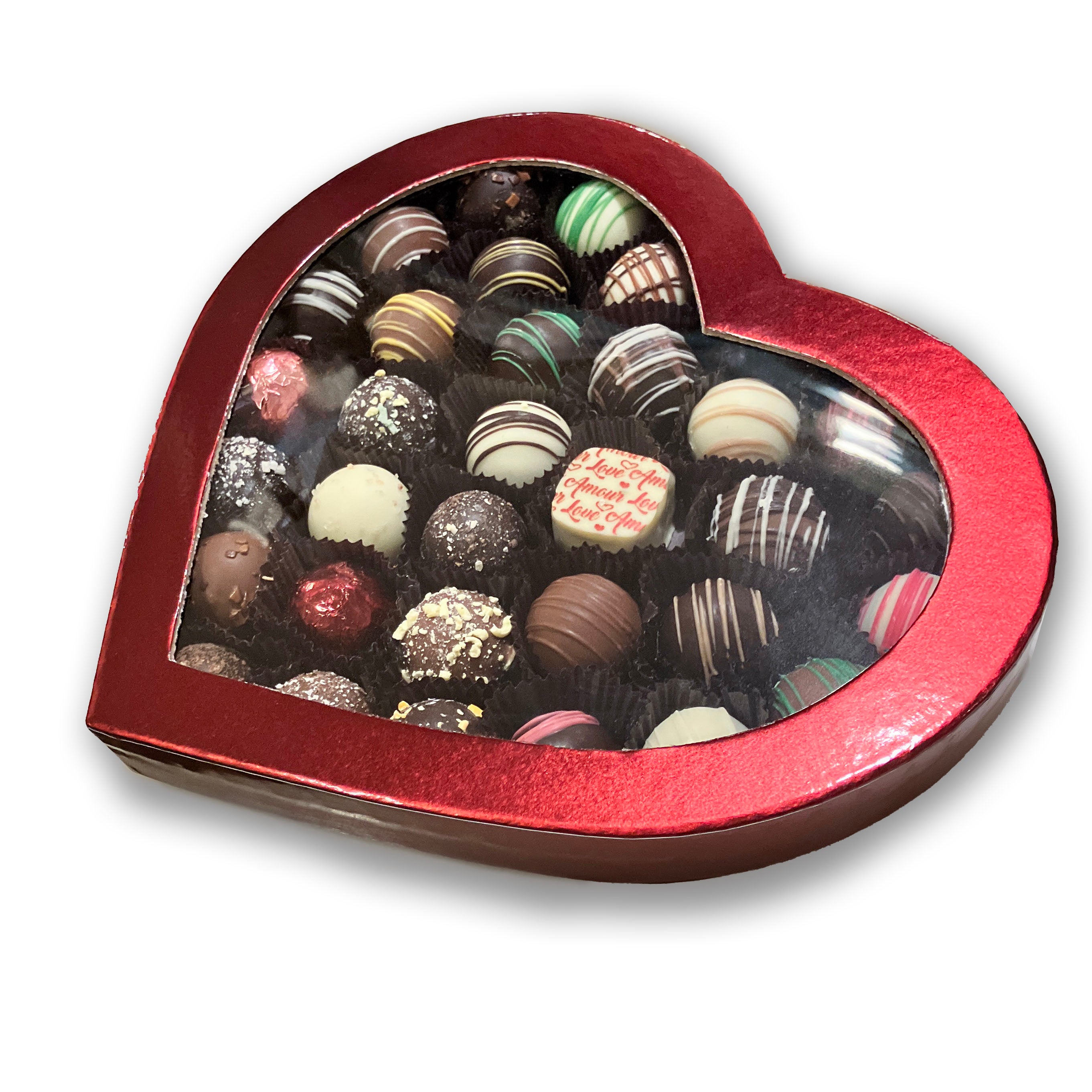Heart-shaped box filled with assorted chocolate truffles on a white background