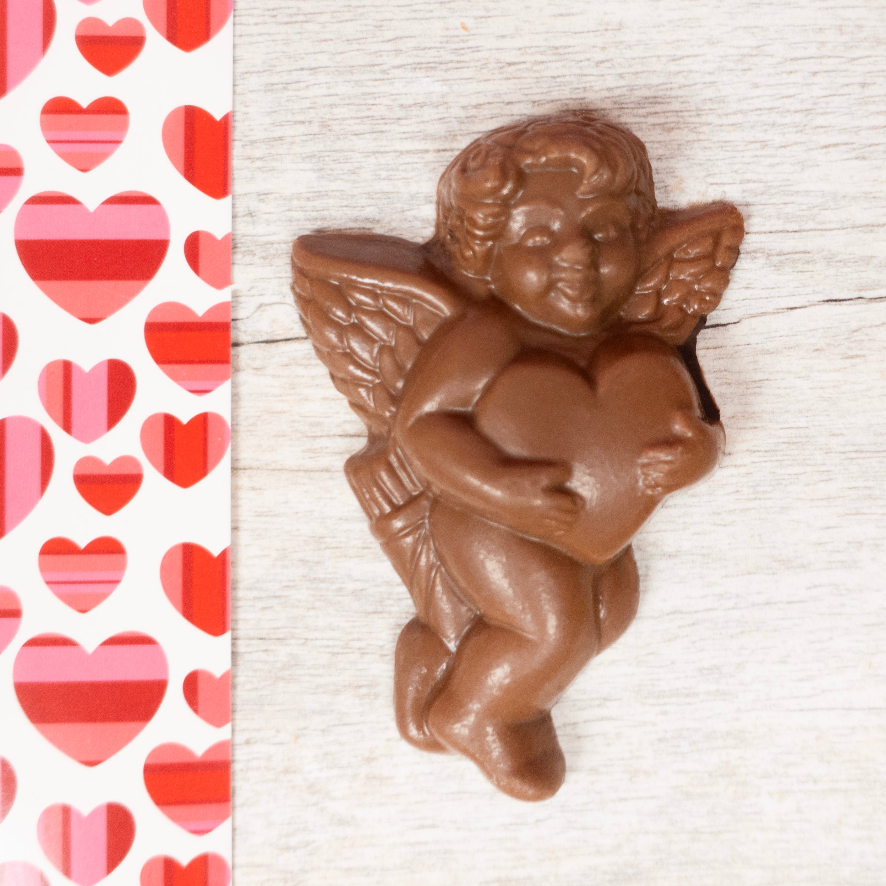 milk chocolate little cupid holding a heart, made and sold by Lore's Chocolates in Philly