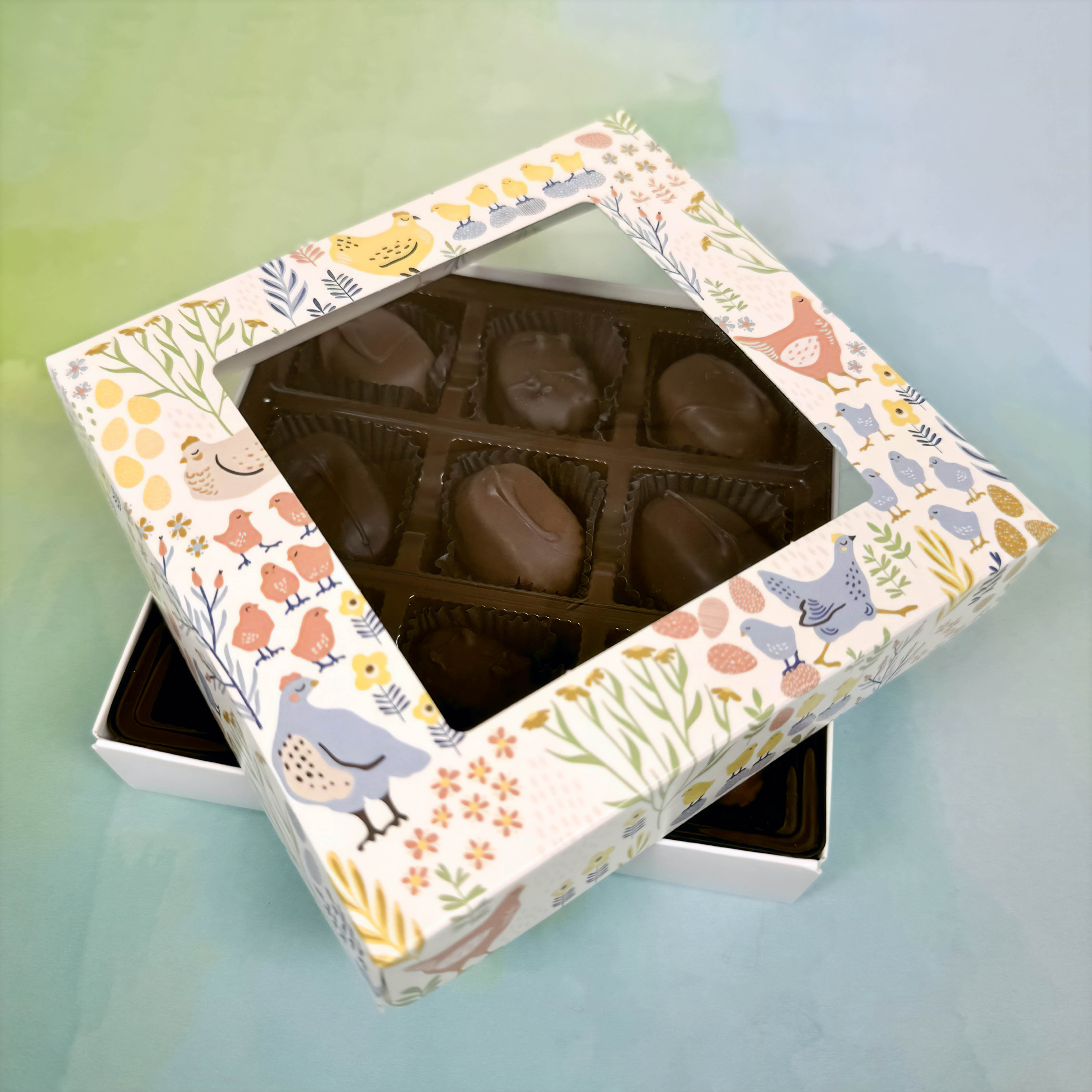 Decorative chocolate box with Easter animal illustrations on a light blue background