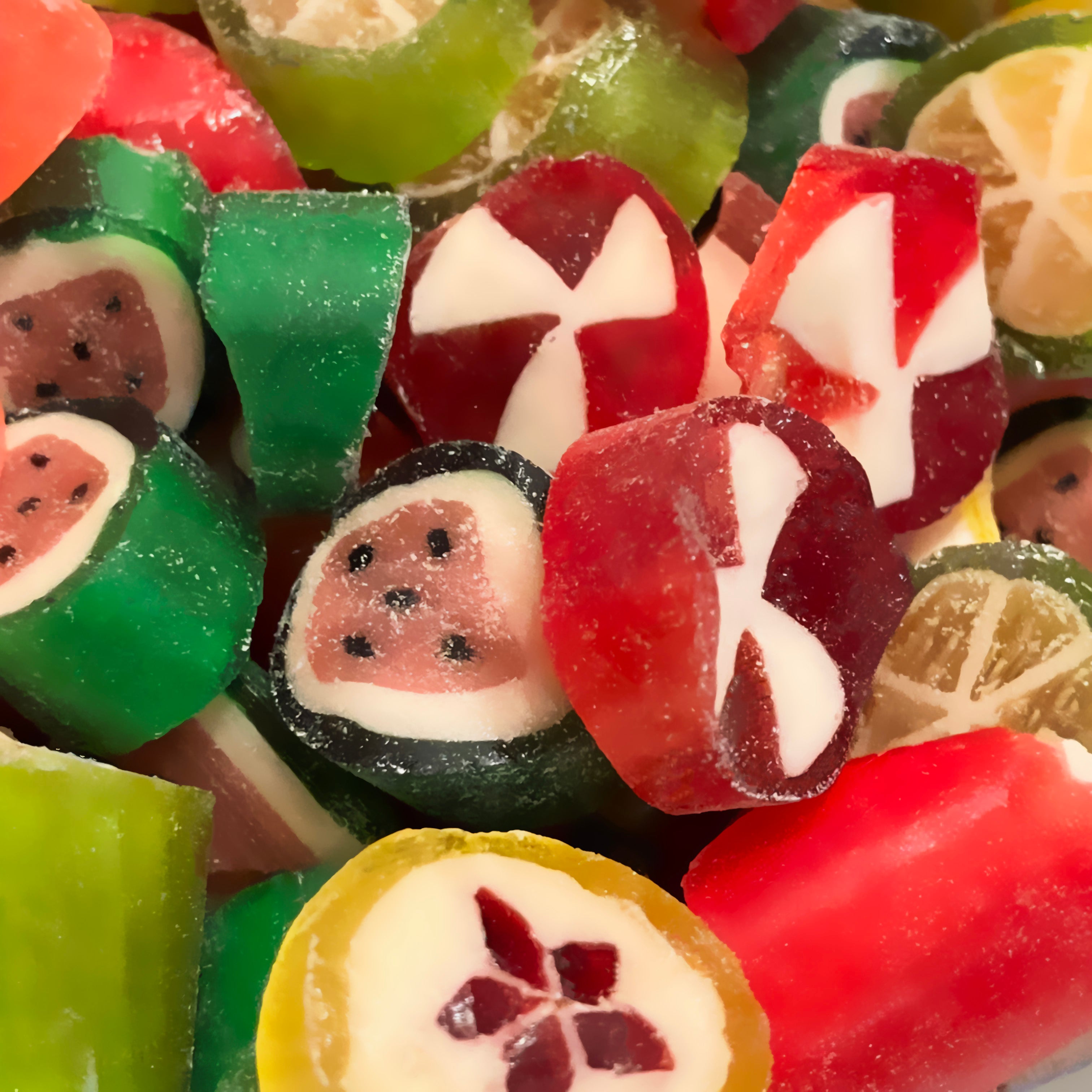 Assorted colorful hard candies resembling fruits and flowers.