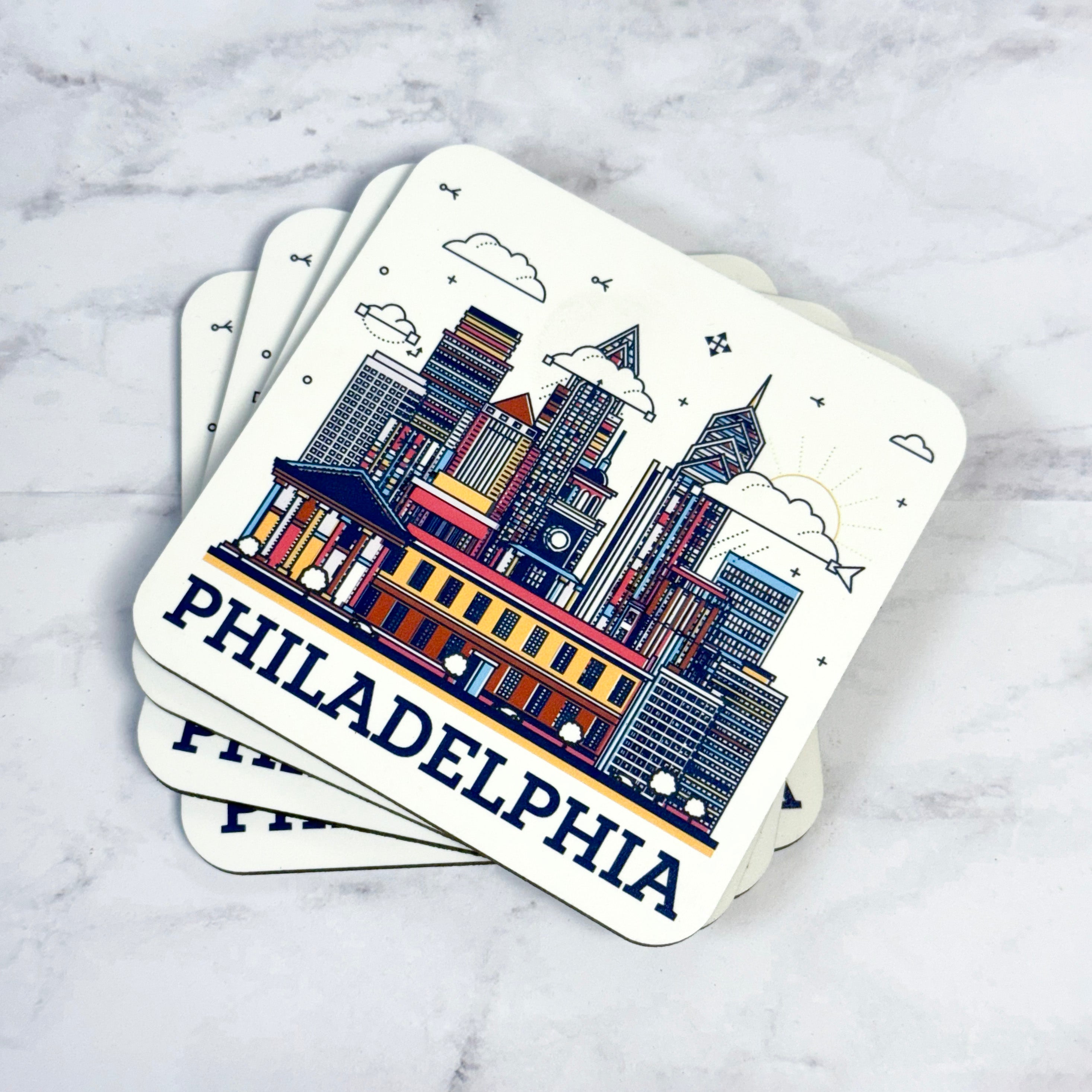 Coasters with Philadelphia skyline design on a marble surface