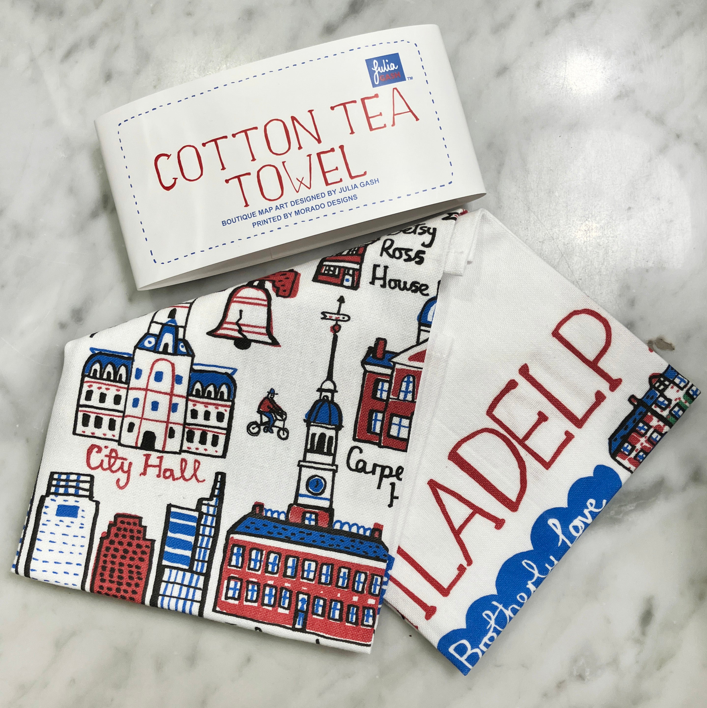 Cotton tea towels with Philadelhpia cityscape design and 'Cotton Tea Towel' packaging on a marble surface
