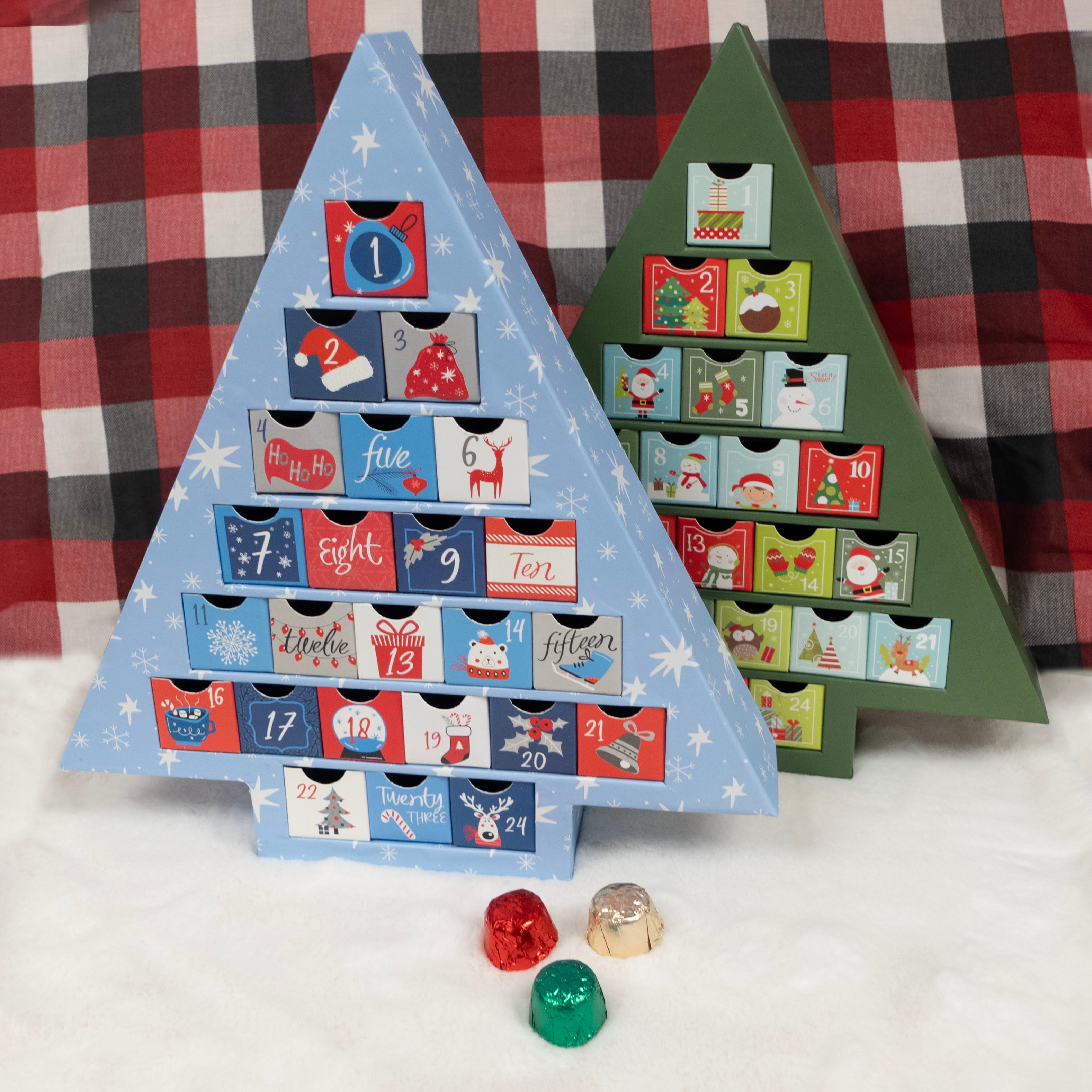 Two triangular wooden advent calendars with colorful doors on a plaid fabric background.