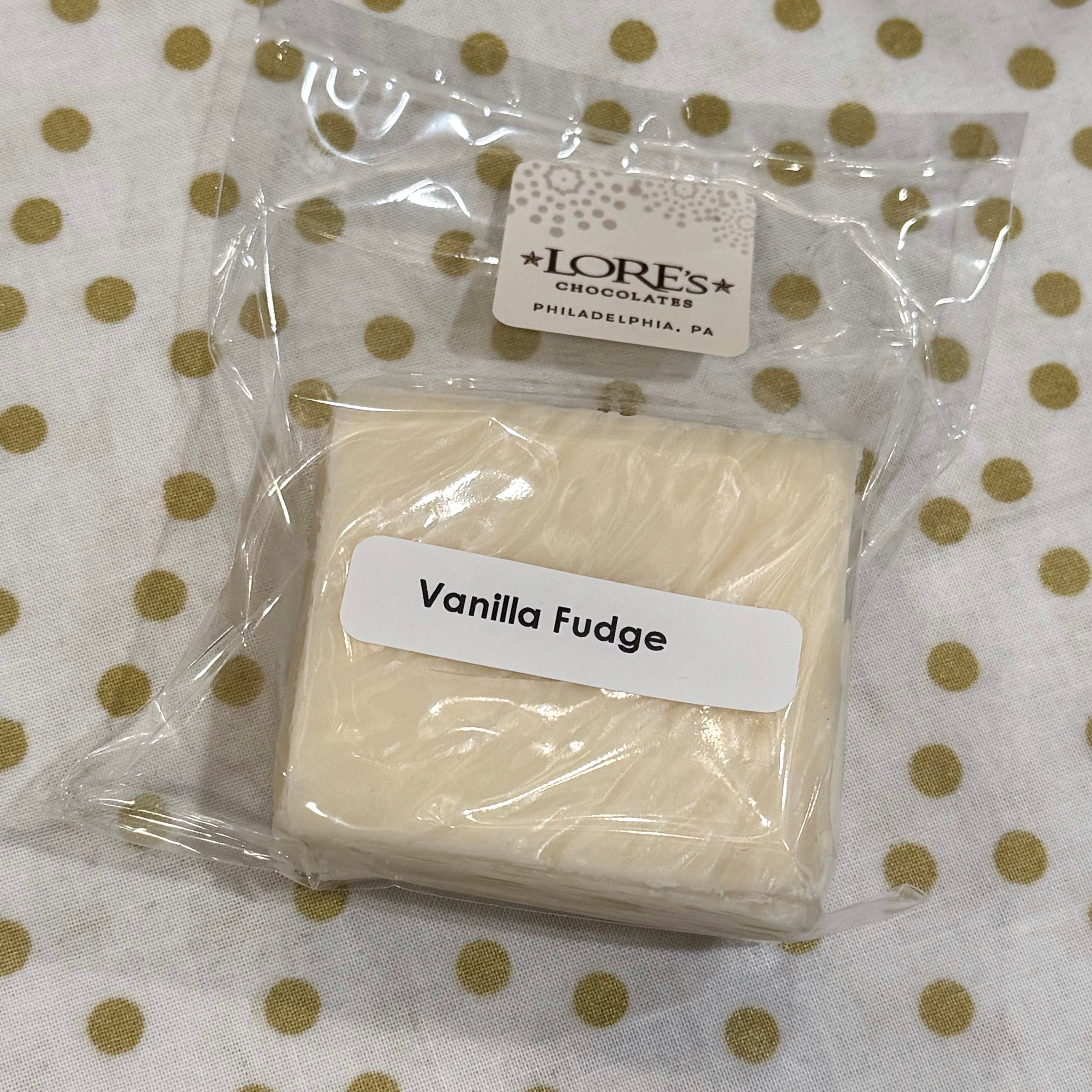 Packaged vanilla fudge with a label on a polka dot background - handmade by Lore's Chocolates in Philadelphia