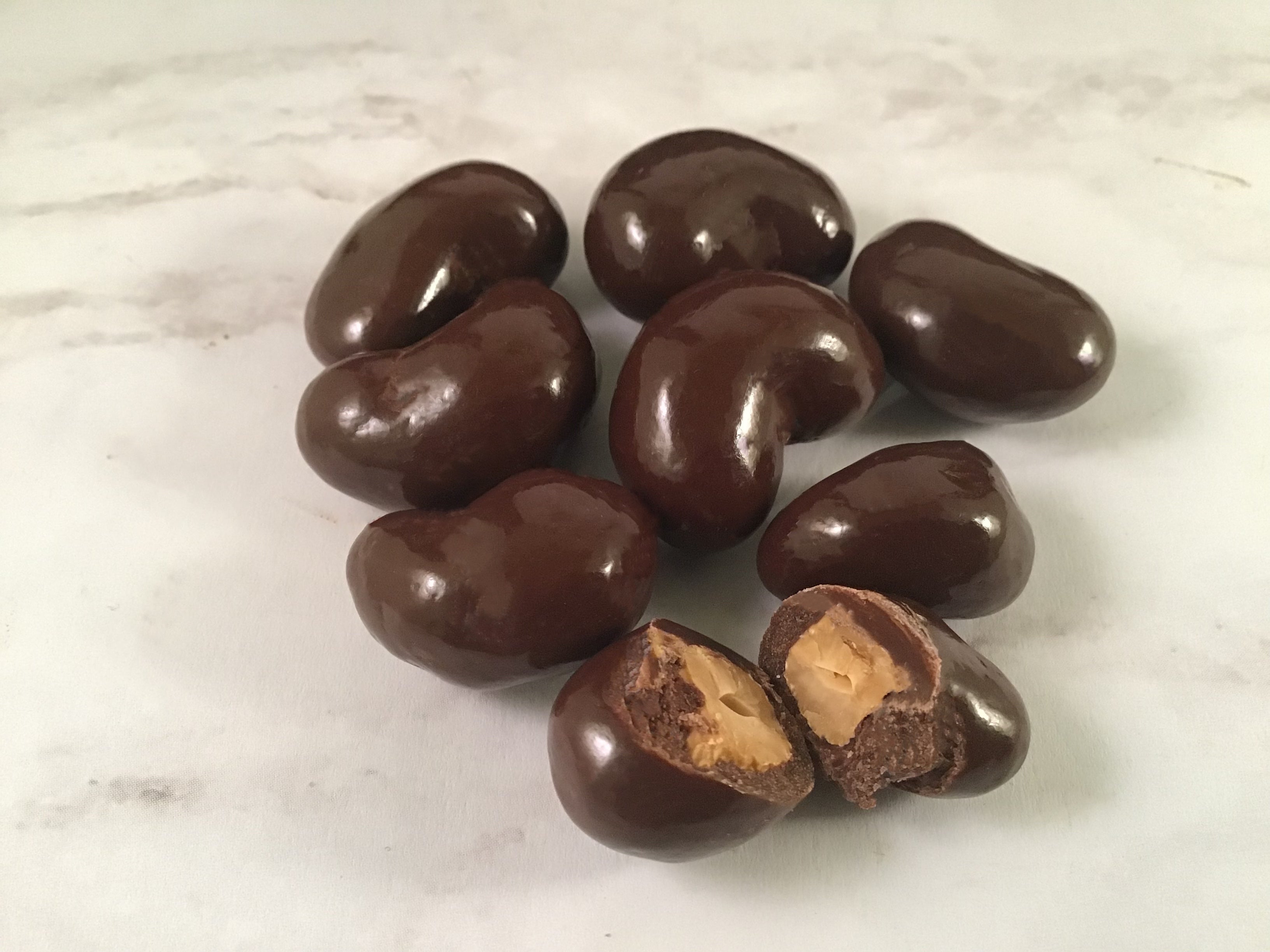 Close up detail of dark chocolate covered sea salt cashew