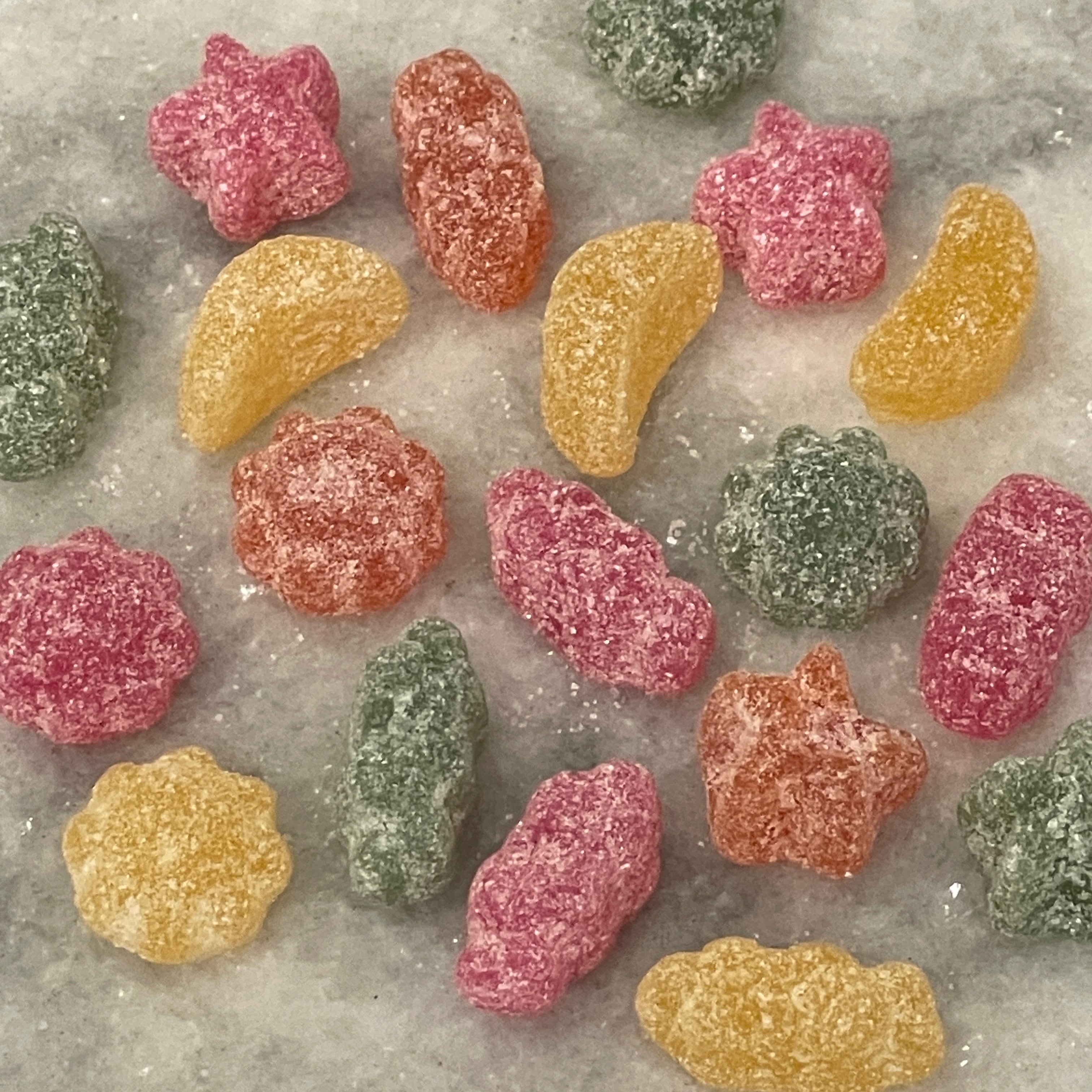 moon, sun, stars, and other celestial shapes in red, orange, yellow, and green gummies
