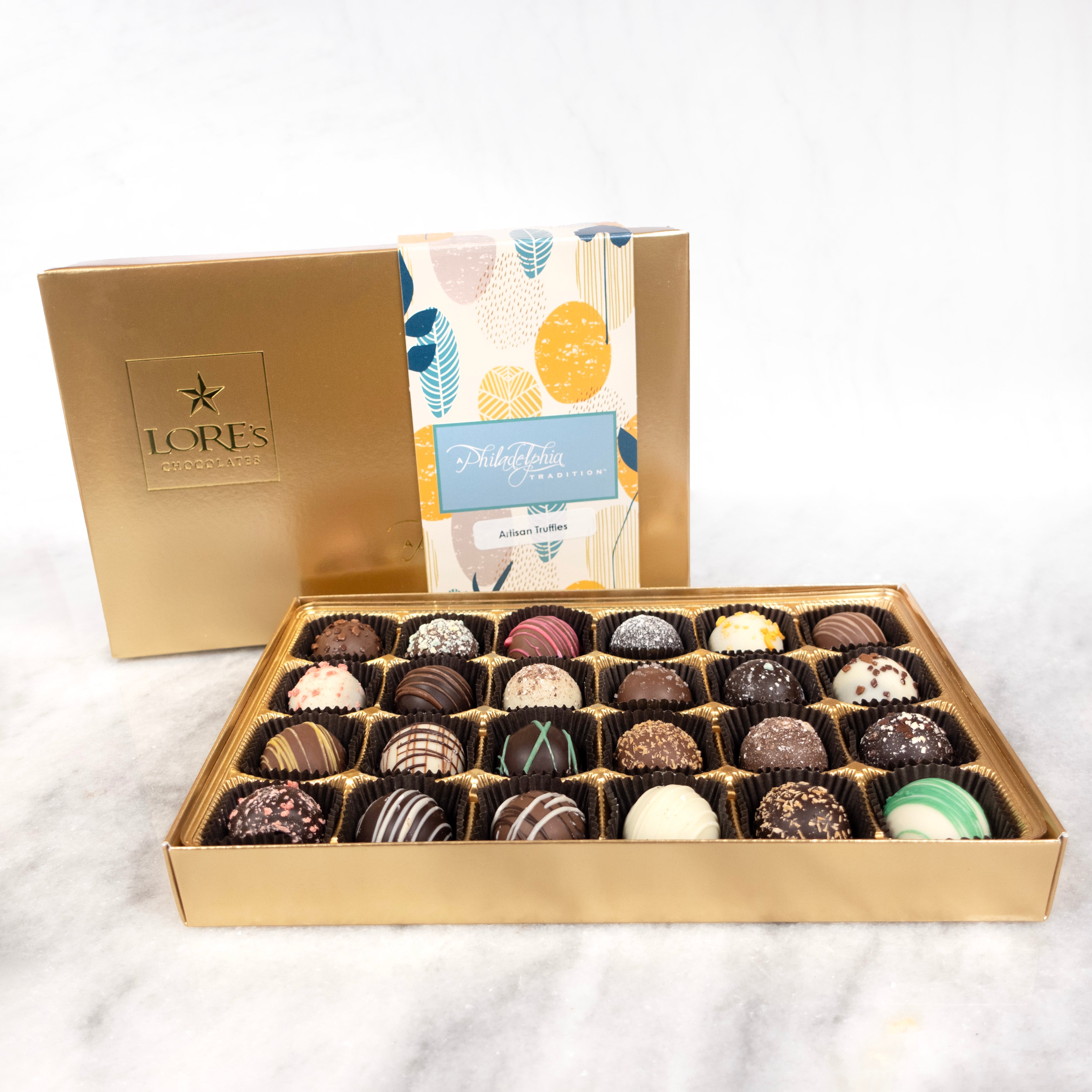 Box of chocolate truffles with a gold lid featuring the brand 'Lore's Chocolates' on a white background.