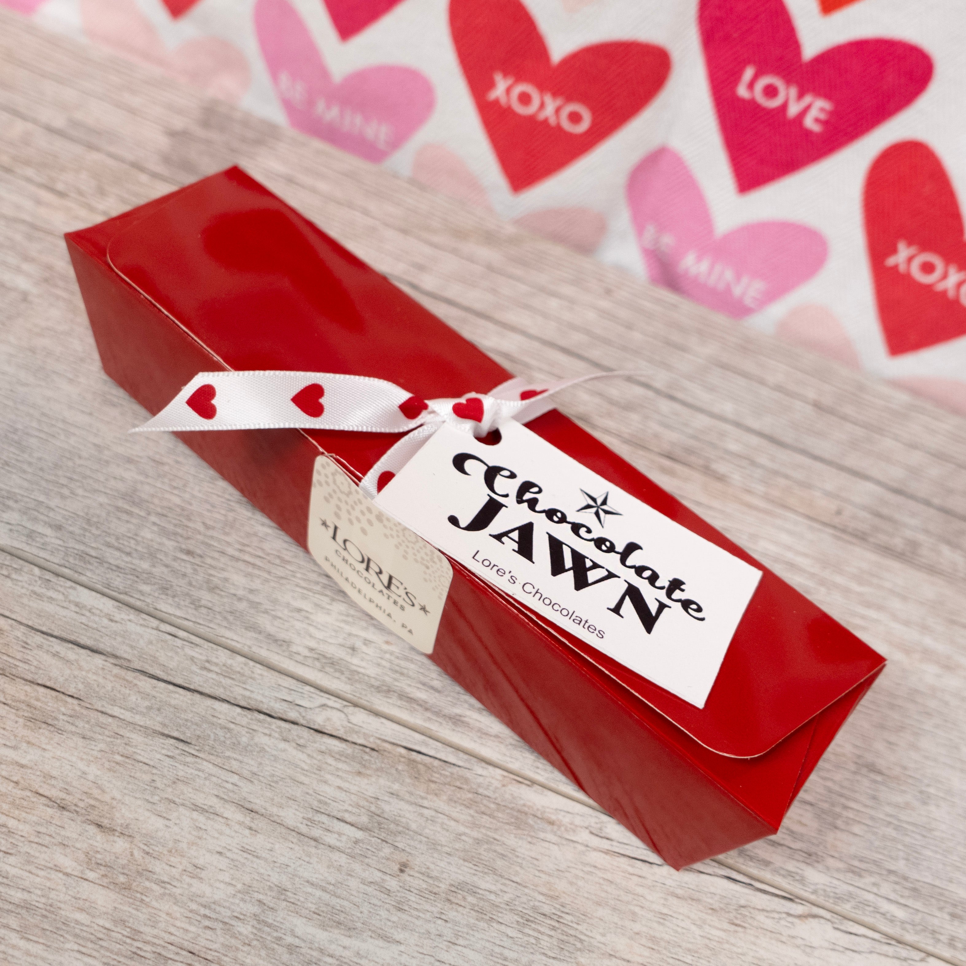 Chocolate Jawn, rectangular box in red color - contents include a mini white LOVE statue chocolate, and artisan truffles with Lore's Chocolates' hang tag