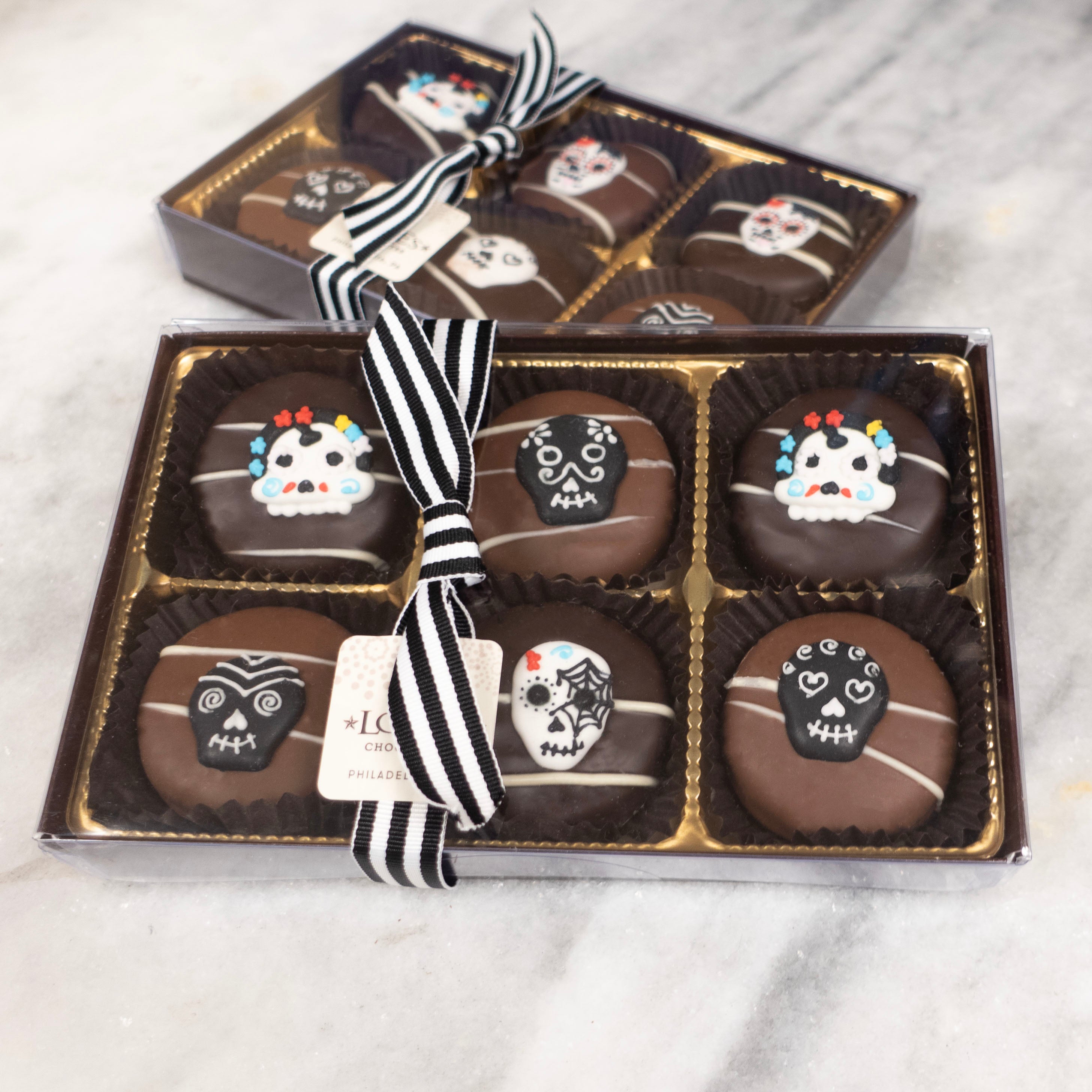 Assorted Chocolate covered oreos with day of the dead sugar skull royal sugar decoration