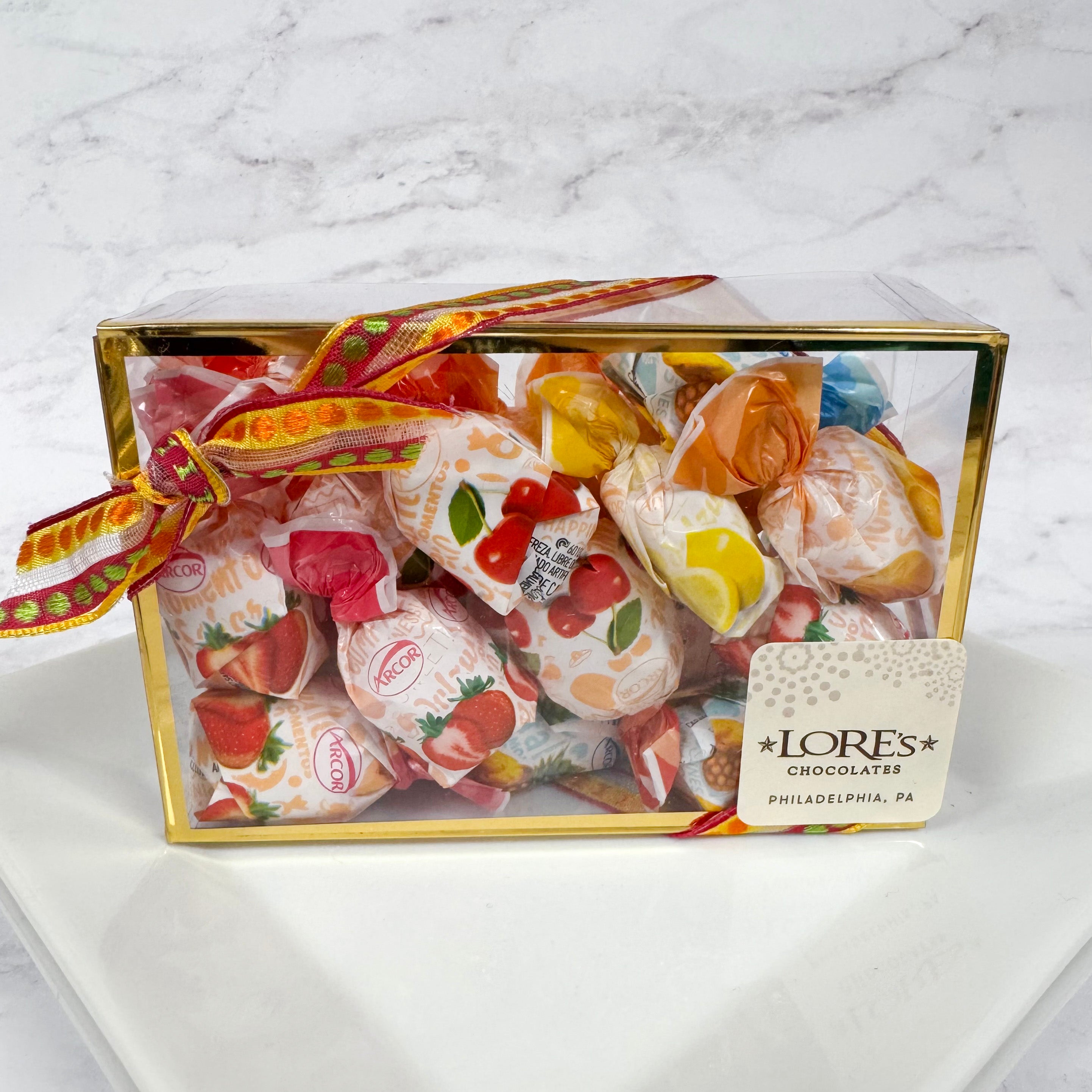 Box of fruit filled hard candies on a marble surface. Sticker reads "Lore's Chocolates in Philadelphia, PA"
