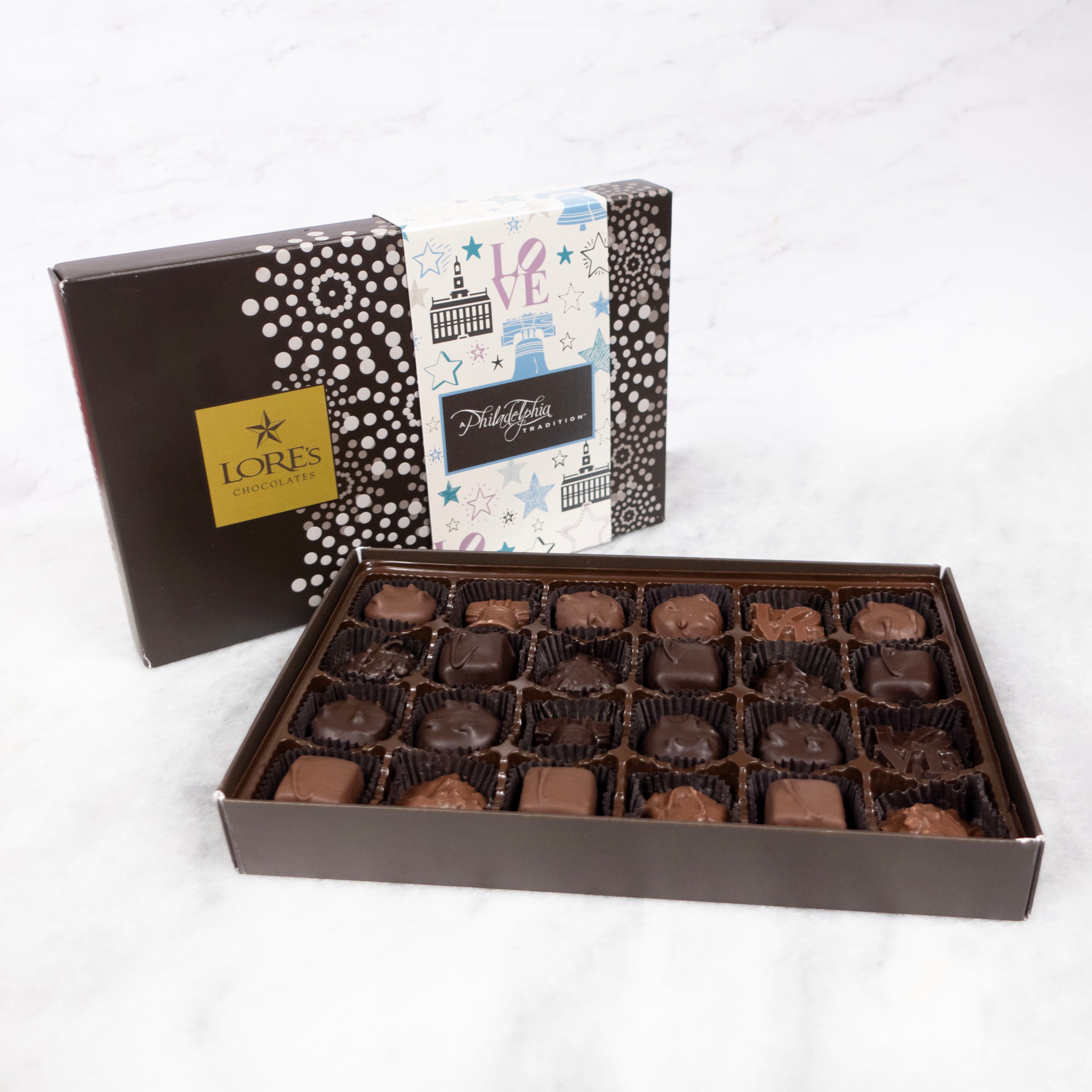 Box of Lore's Philadelphia chocolates with a decorative cover on a white background