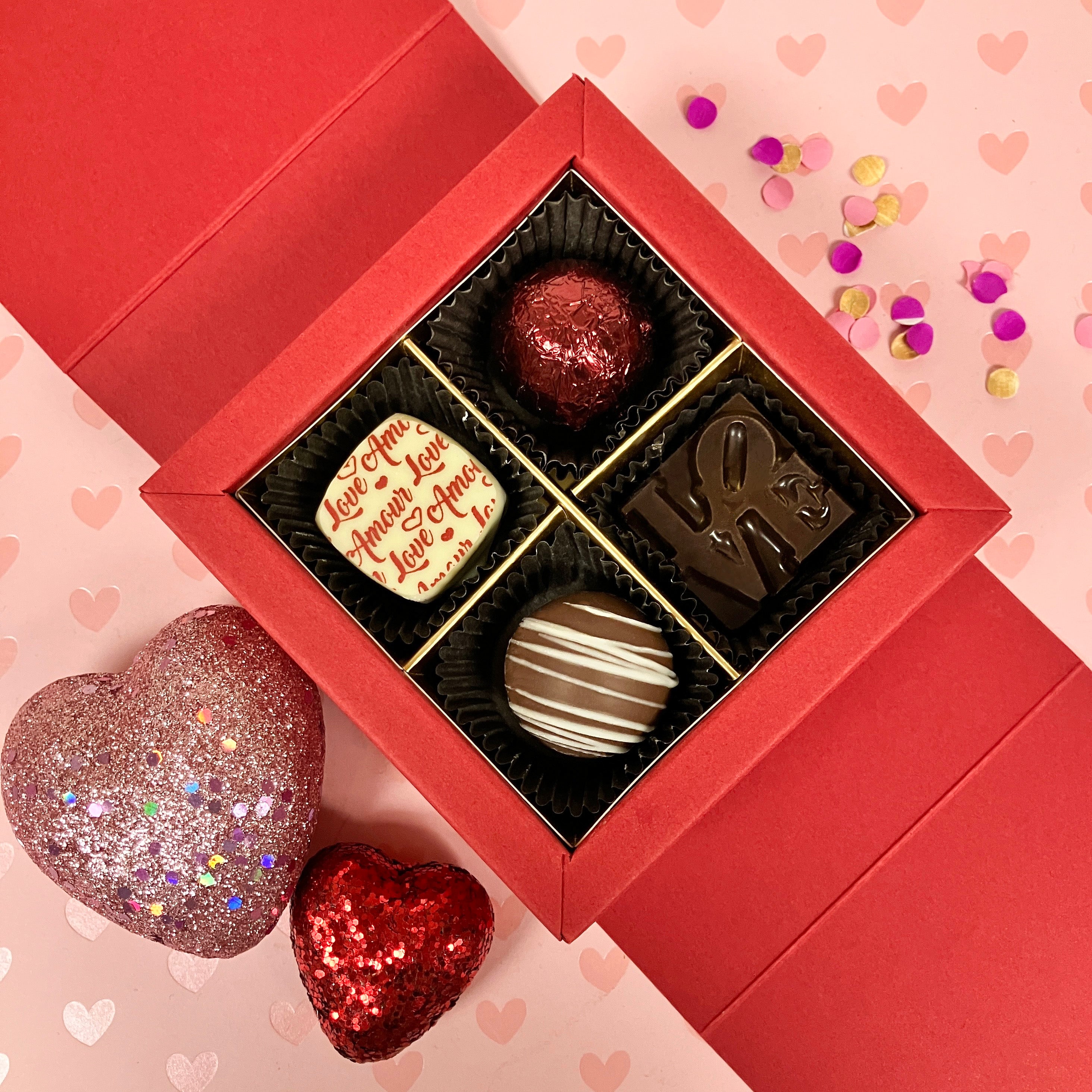 Red chocolate box with assorted chocolates and truffles on a heart-themed background