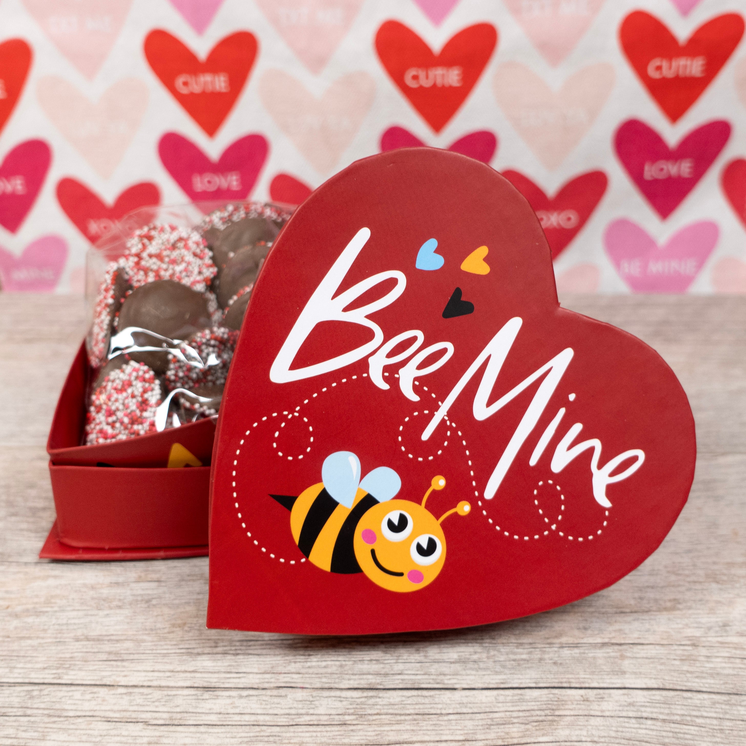 Valentine's Day Heart-shaped box reading "Bee Mine" with a cute illustrated bumble bee - inside the box is valentine's day colored nonpareils in milk chocolate