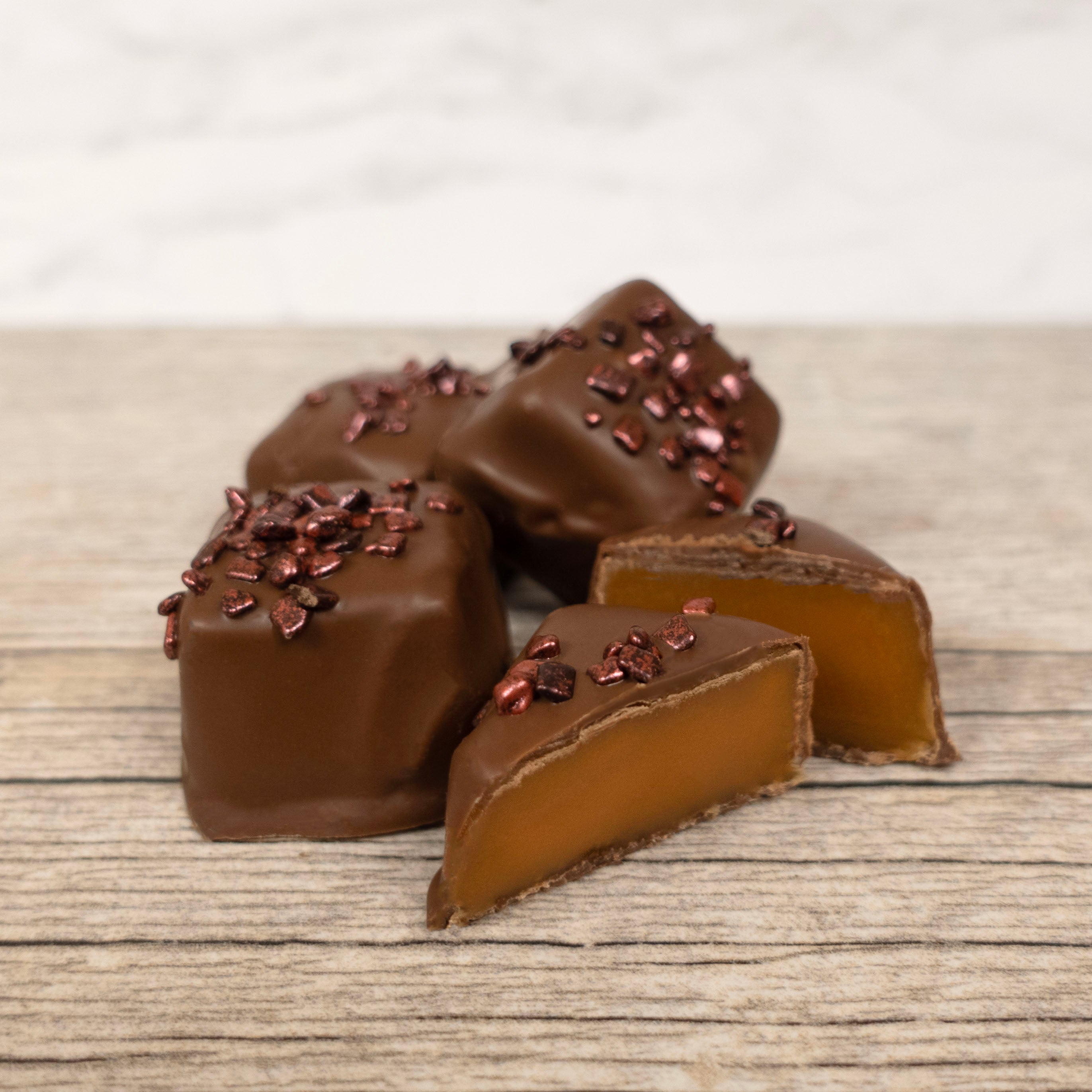 Lore's Chocolate-covered caramel pieces on a wooden surface