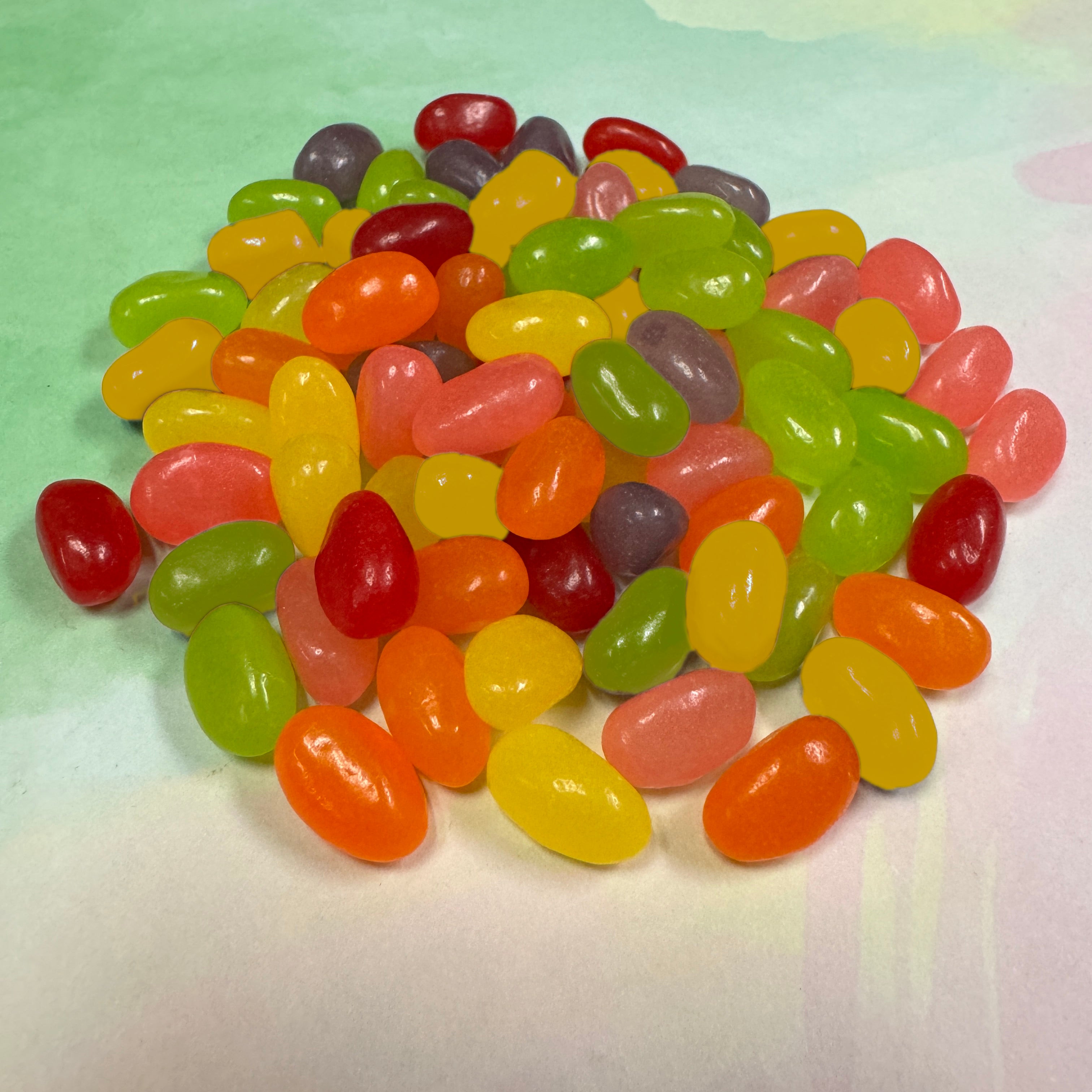 Assorted colorful jelly beans on a light green background