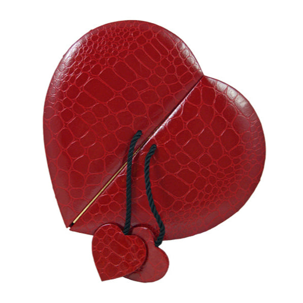 Heart shaped box with a crocodile/alligator leather pattern, opens in the middle with black cord with small alligator heart on either door.  (Contains Artisan Truffles from Lore's Chocolates)