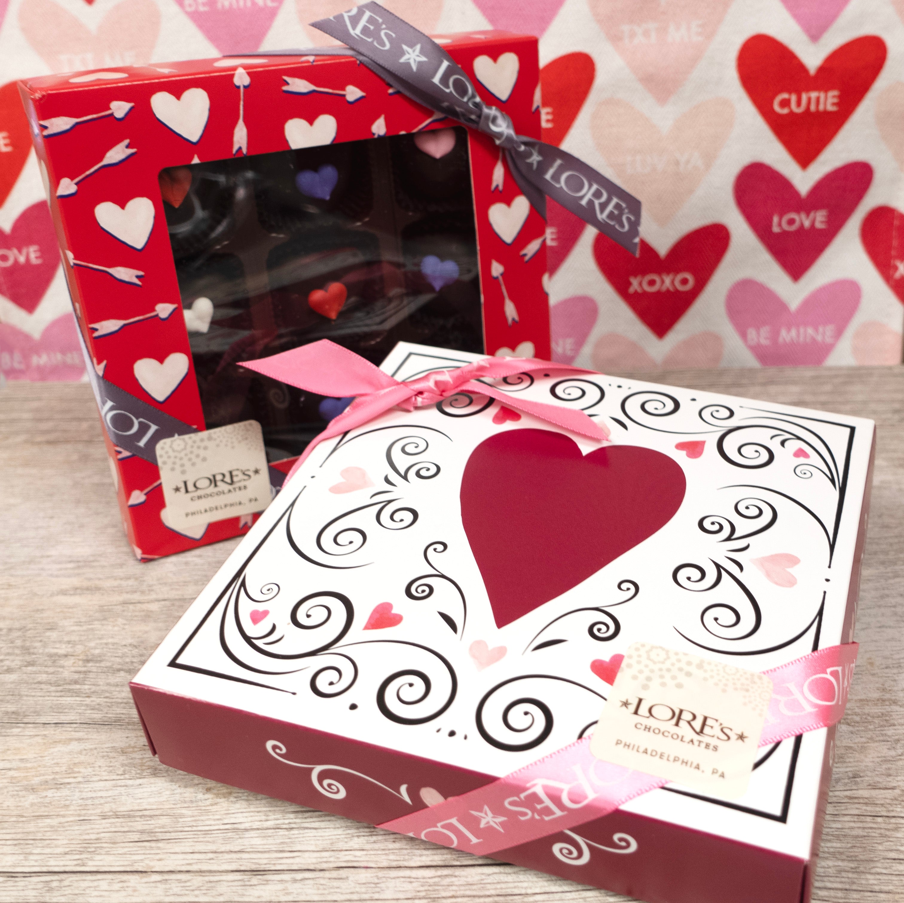 White box with dark red heart and black swirls - contains 9 Lore's decorated dark chocolate hearts filled with mint cream. Other box design in background.