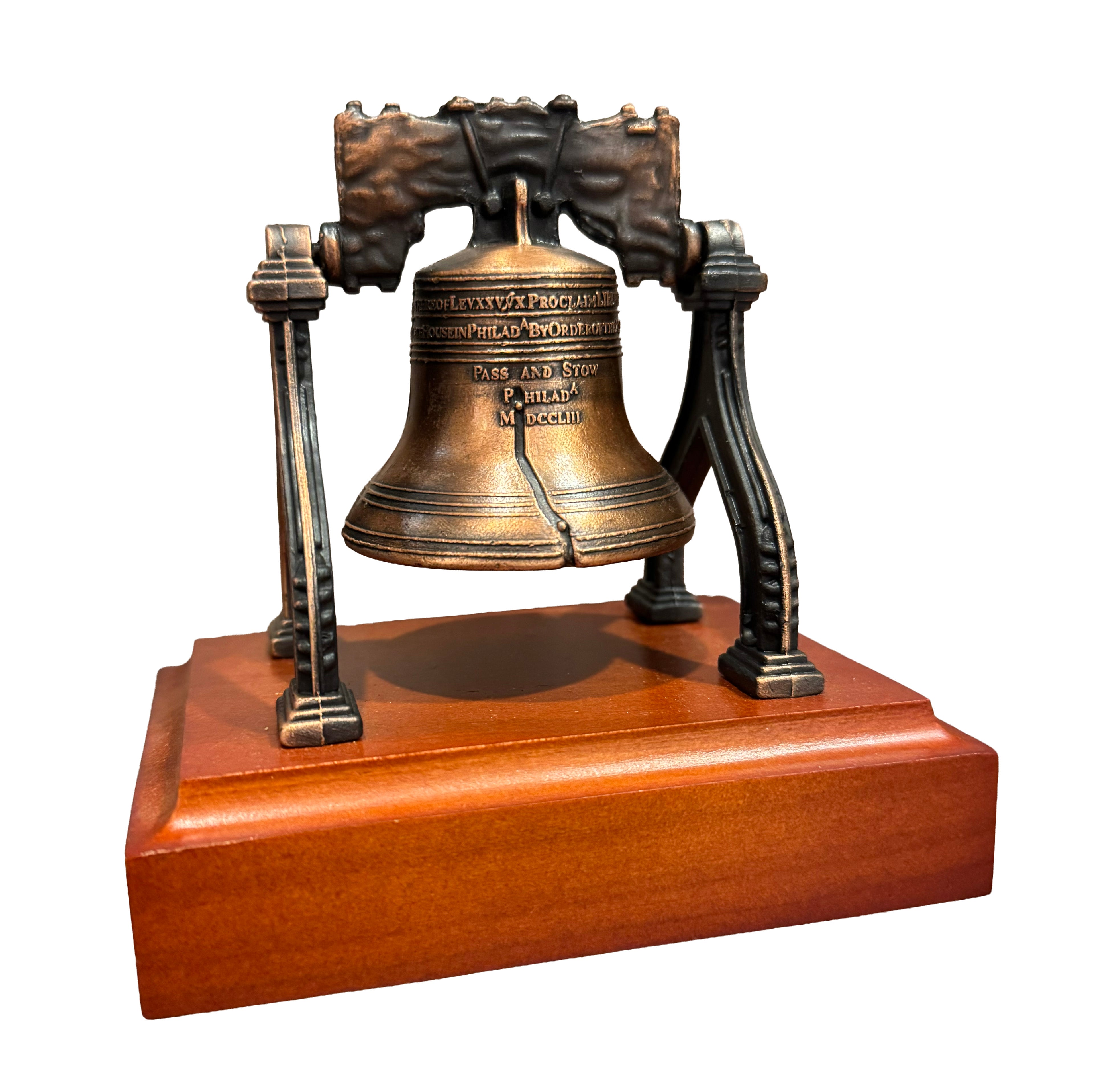 philadelphia souvenier Bronze liberty bell on a wooden base with a white background 