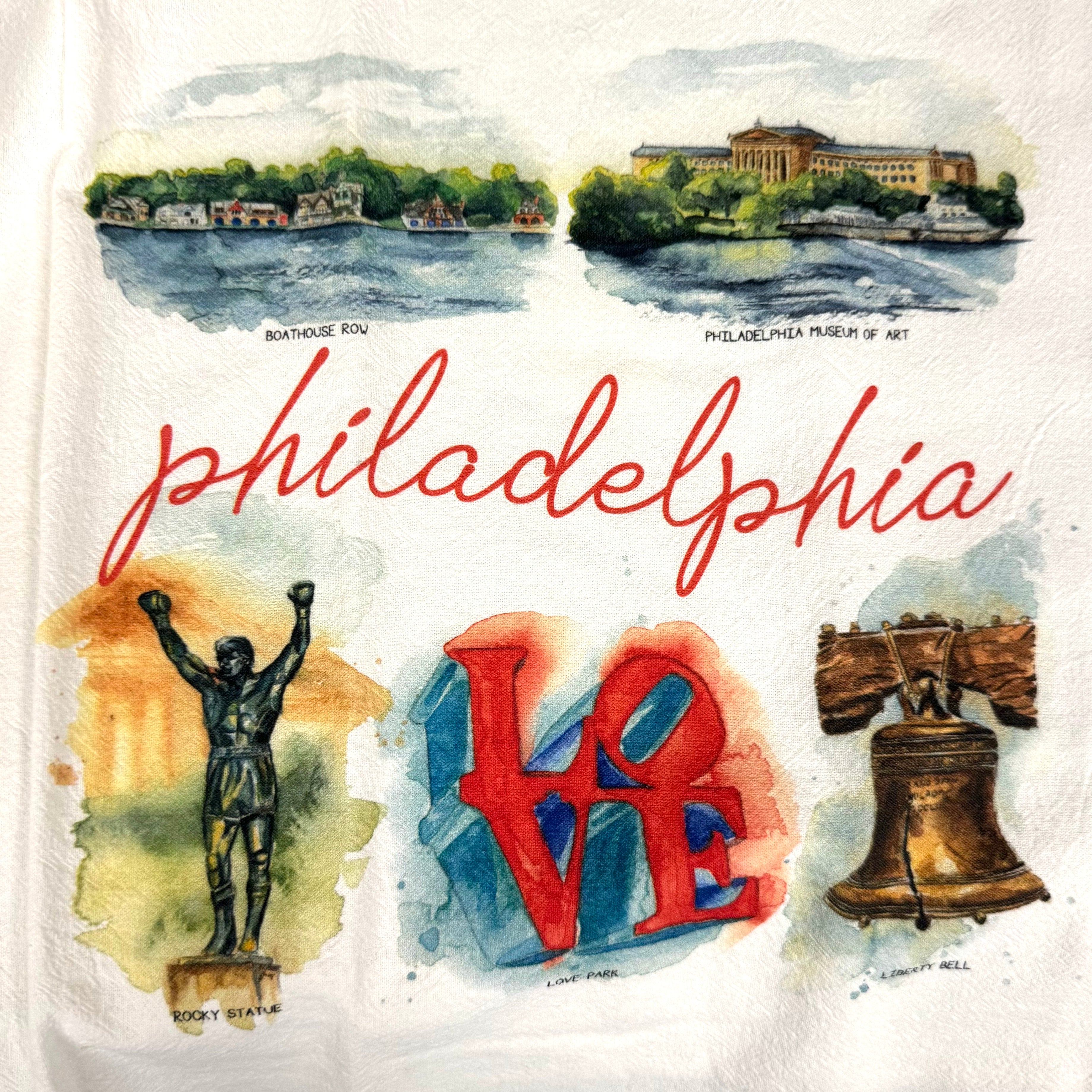 Close up of tea towel: Illustration of Philadelphia with famous landmarks and the word 'Philadelphia'. Sold at Lore's Chocolates in Philadelphia