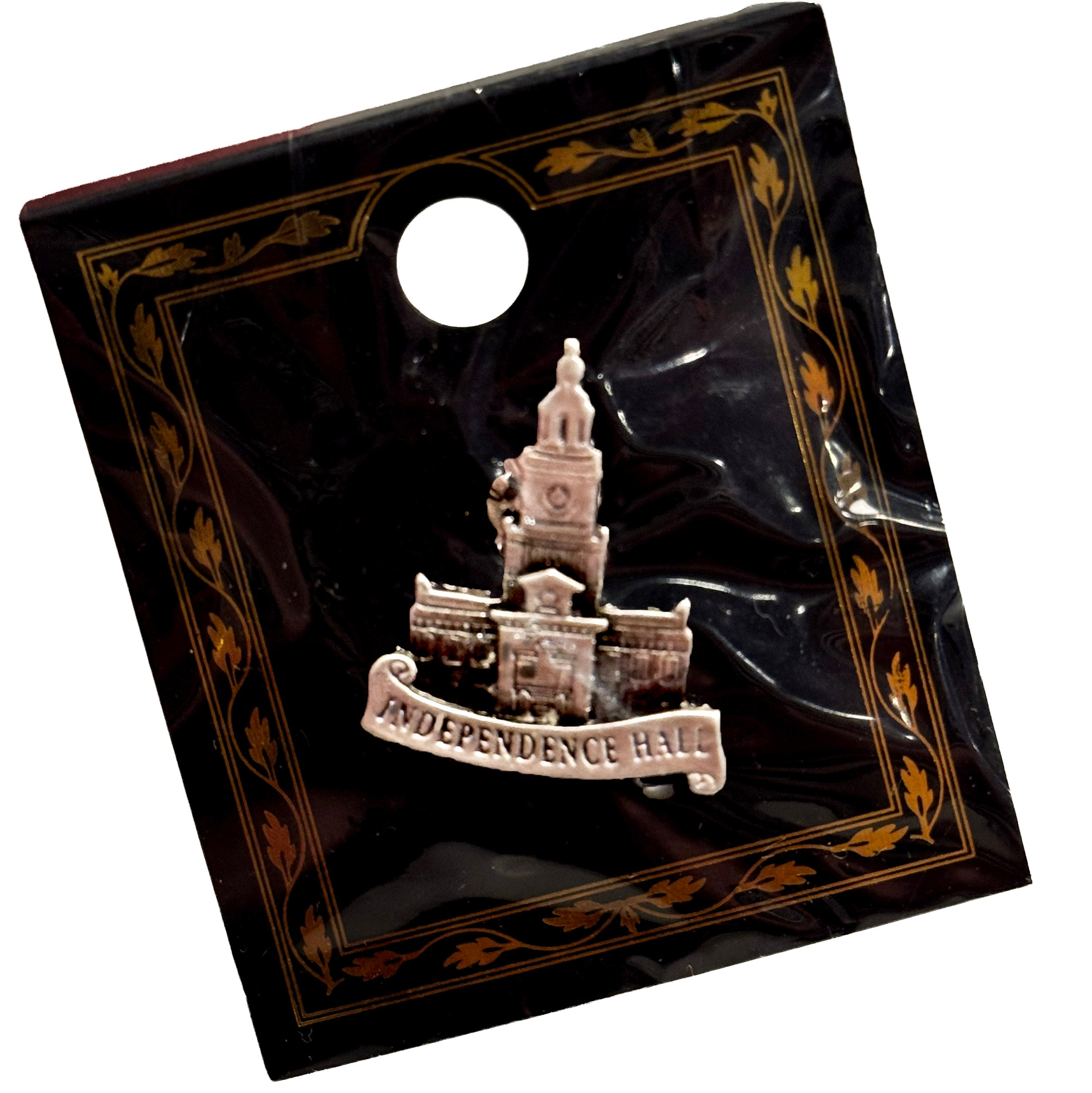Decorative small pin with Independence Hall design on a black background card
