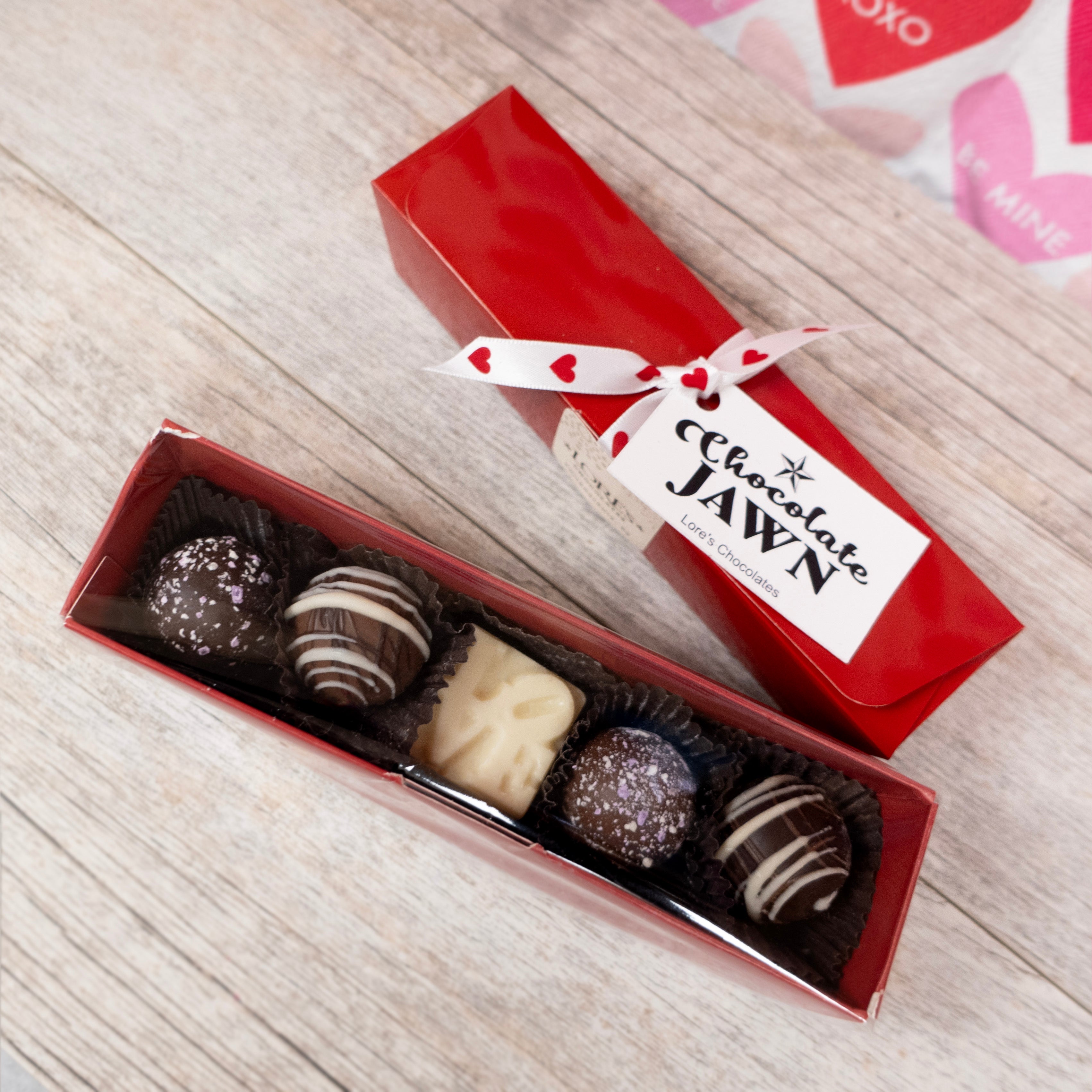 Chocolate Jawn, rectangular box in red color - contents include a mini white LOVE statue chocolate, and artisan truffles 