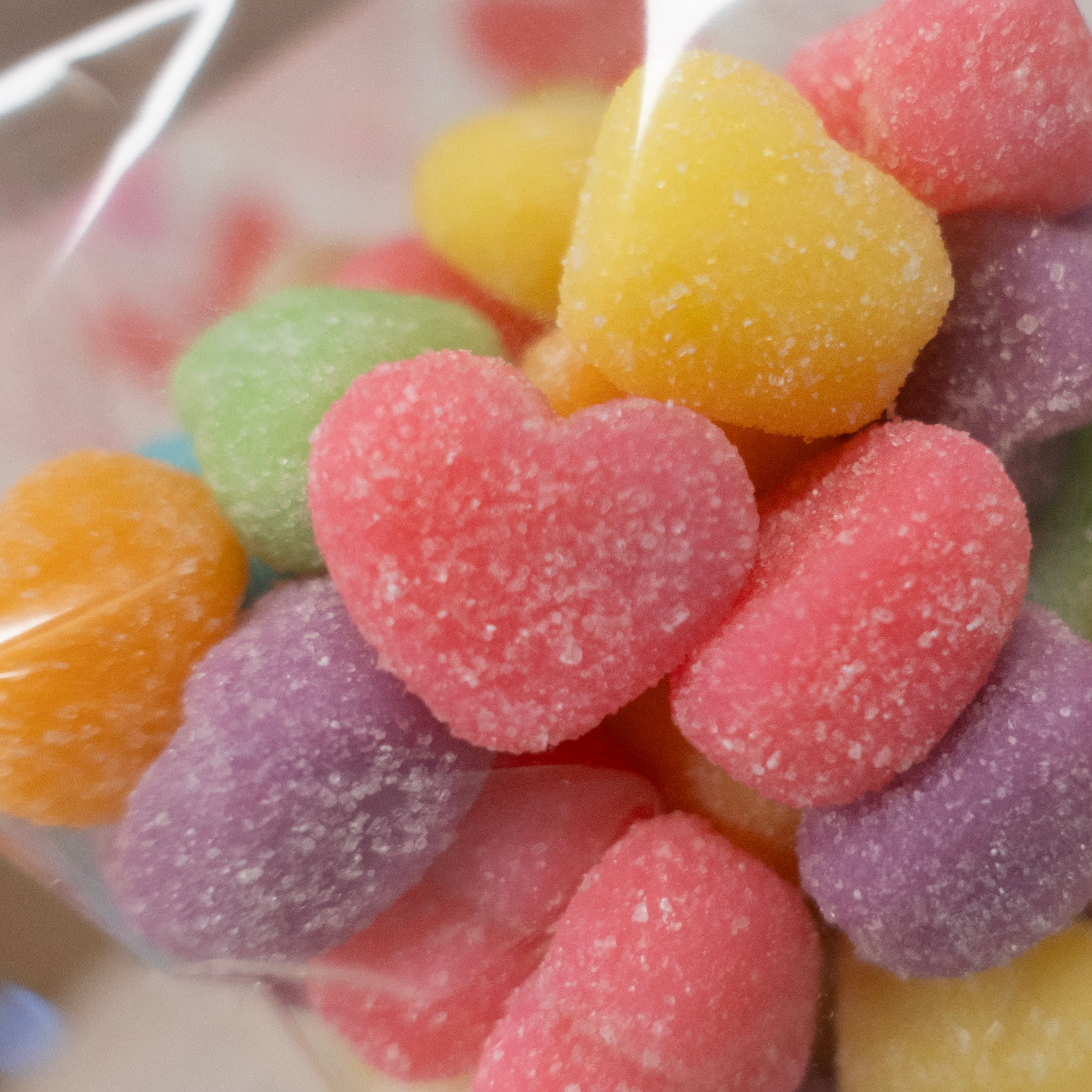 close up of rainbow colored gummies in the shape of hearts for valentine's day pink, green, orange, purple, blue, yellow sold at Lore's Chocolates